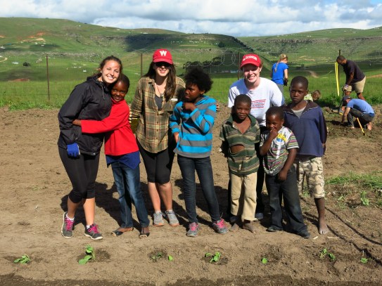  Students from a prior UW student-learning course pose with their fellow workers in the school garden